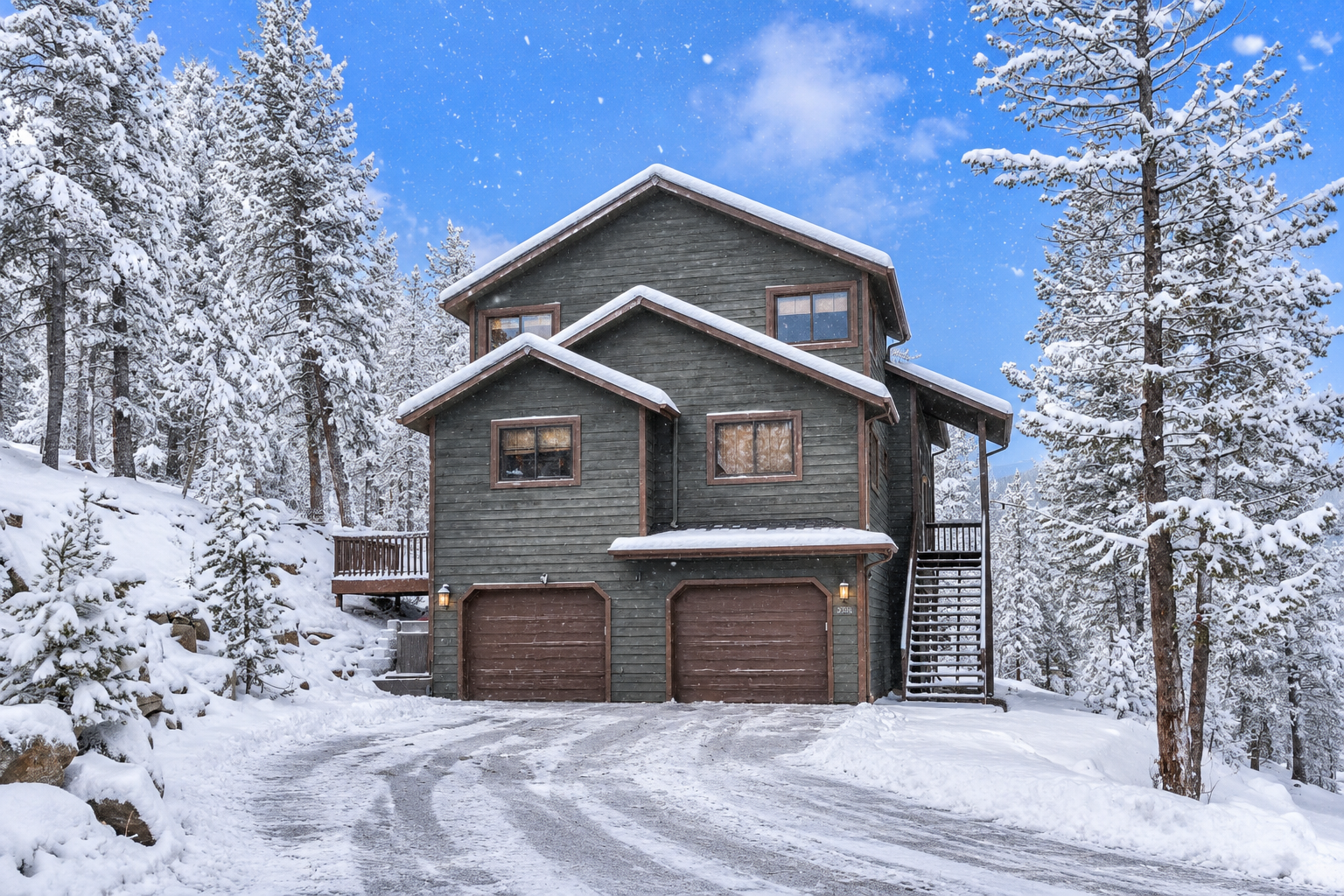 Multi-story green home in snowy forest