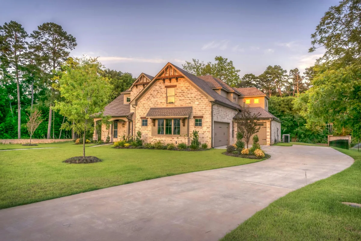 Exterior example showing the house, entrance, lawn and driveway in one view.